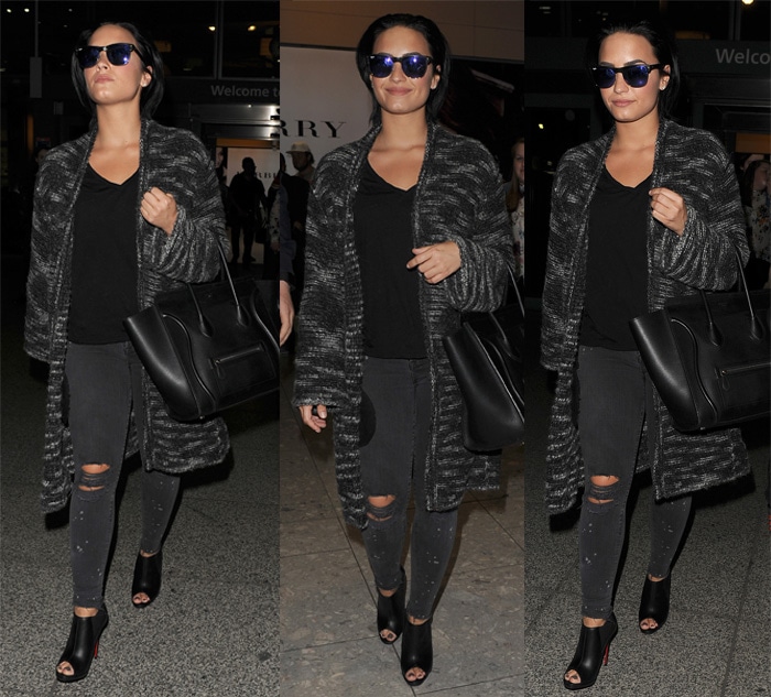 Demi Lovato keeps it effortlessly chic for travel in a cozy Zadig Voltaire coat, distressed skinny jeans, peep-toe Christian Louboutin booties, and her go-to Celine tote while arriving at Heathrow Airport in London on September 7, 2015