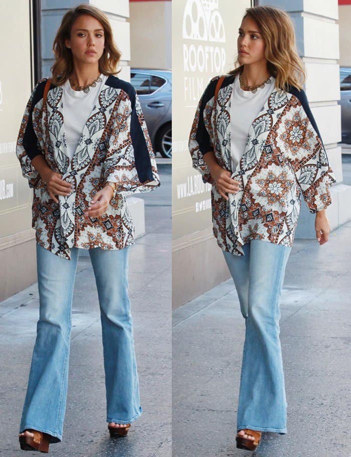 Jessica Alba steps out in Hollywood wearing flared Madewell jeans and a printed Cleobella kimono, accessorized with a Loeffler Randall Cuoio backpack and platform sandals for effortless boho flair