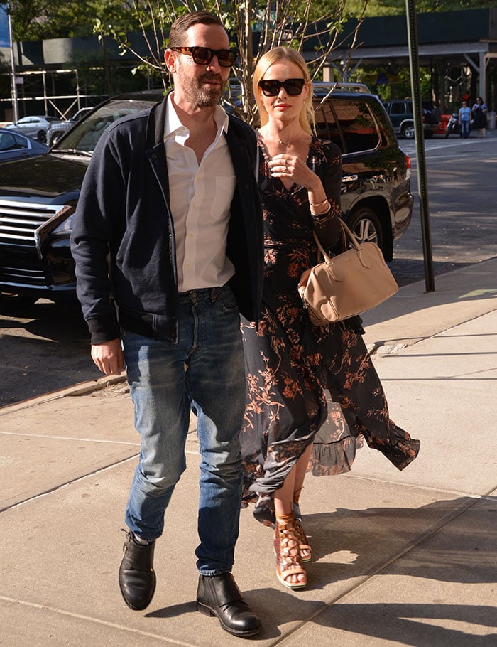 Michael Polish complements Kate Bosworth's romantic look with a crisp white shirt, jeans, and a navy bomber jacket during their stylish stroll in New York City