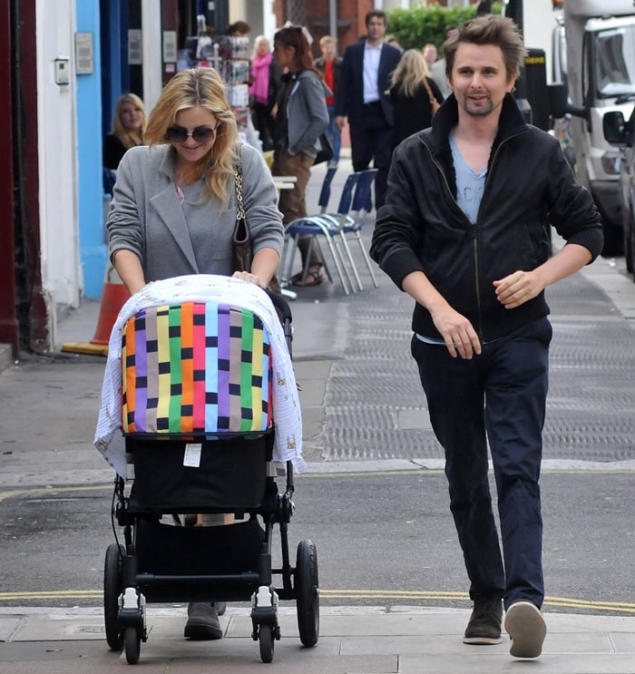 Kate Hudson leans into off-duty ease in flat ankle boots and relaxed tailoring while strolling London streets with Matthew Bellamy and baby Bingham in 2011