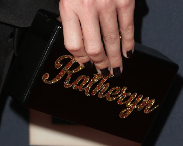 Katy Perry matches her manicure to her black Edie Parker clutch