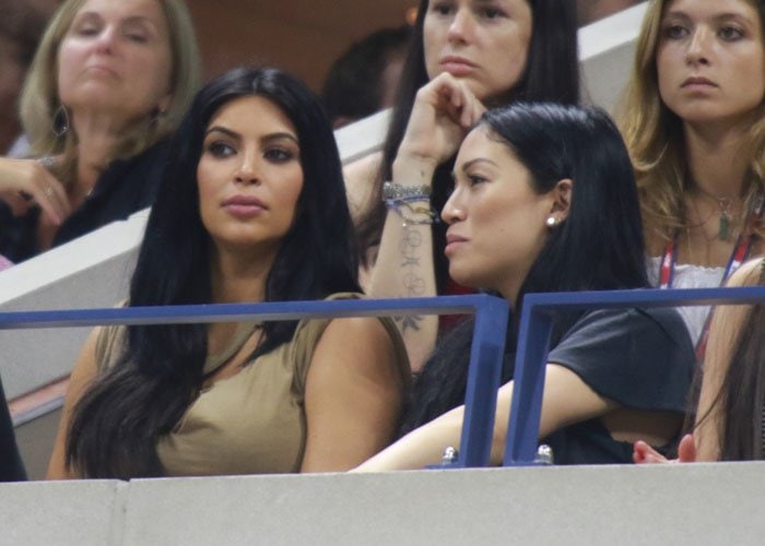 Kim Kardashian sits in the stands during the U.S. Open tennis match