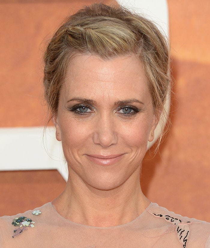 Kristen Wiig’s softly braided updo and smoky eye makeup balanced the romance of her sheer, embroidered Valentino dress with a polished red-carpet finish