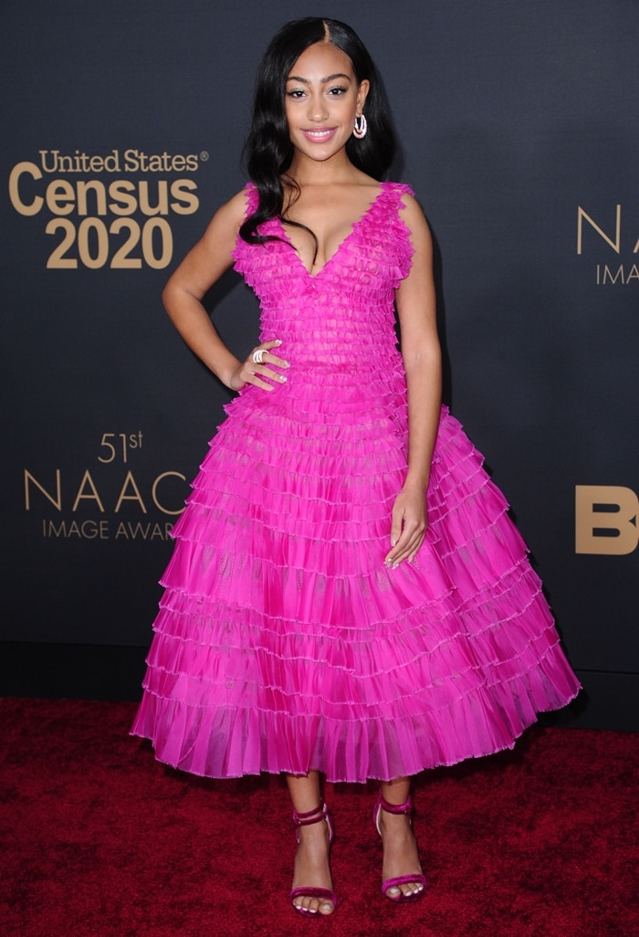 Lexi Underwood brightens the red carpet in a tiered hot pink J. Mendel dress paired with matching strappy Chloe Gosselin sandals at the 51st NAACP Image Awards on February 22, 2020, in Pasadena, California
