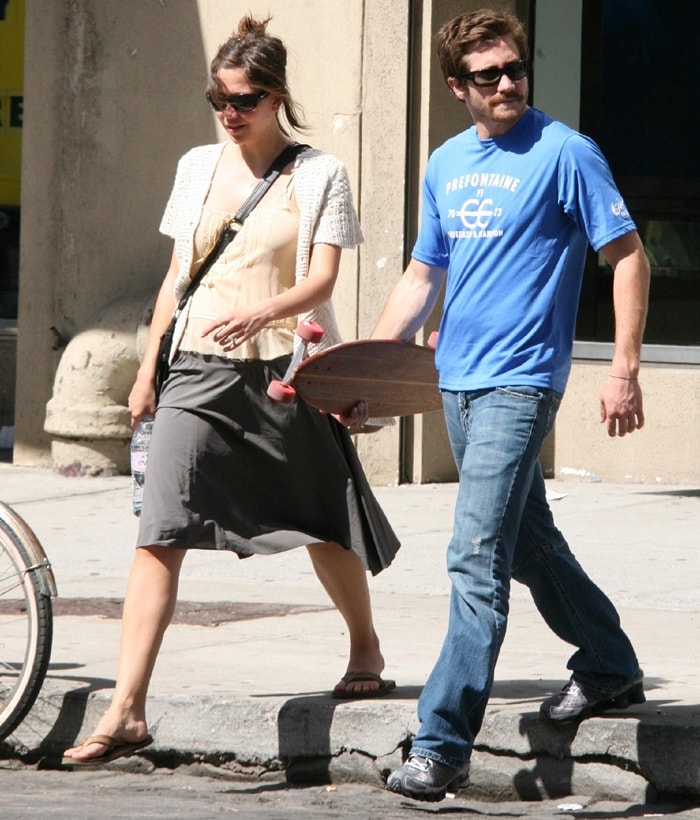 Maggie Gyllenhaal keeps it casual in a flowy gray skirt, crochet cardigan, and strappy flat sandals while out shopping with brother Jake in NYC’s Meatpacking District
