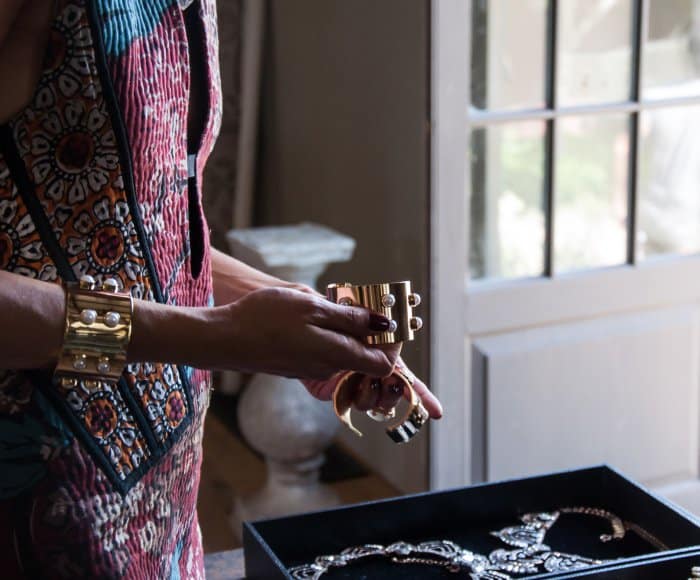 Olivia Palermo curates her BaubleBar collection, showcasing bold gold cuffs adorned with intricate details, perfect for making a statement