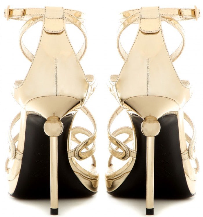 Roger Vivier “Ondulation” metallic gold leather sandals showcase the line’s signature undulating straps and sleek stiletto heel, creating a fluid, jewelry-like effect for evening wear