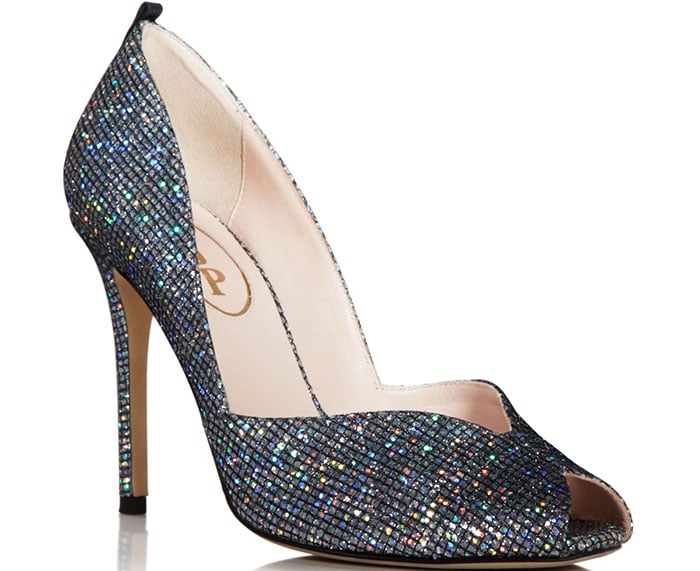 The SJP “Naomi” peep-toe pump dazzles with its multicolor glitter finish and sleek, high-heel silhouette, delivering classic Sarah Jessica Parker sparkle with every step