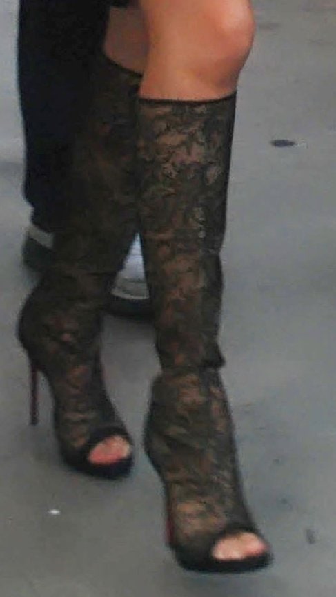 Selena Gomez elevates her look with Christian Louboutin’s intricate lace peep-toe boots, blending sultry glamour with timeless Parisian craftsmanship