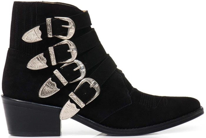 This smooth suede iteration emphasizes the boots’ clean profile, angular heel, and polished metal detailing