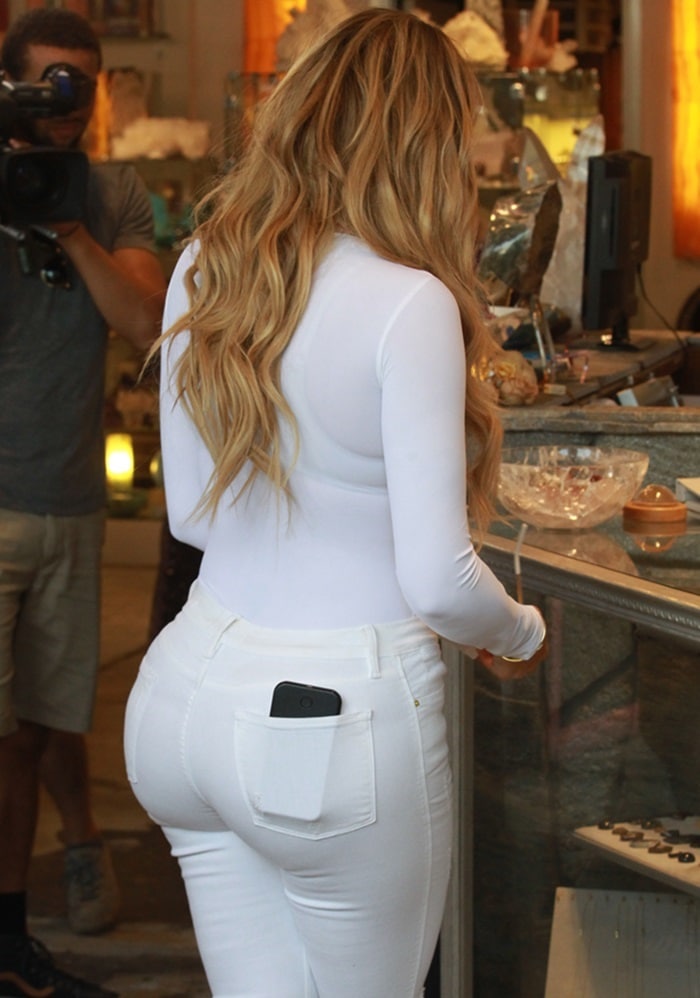 Khloé Kardashian flaunts her backside in a pair of skintight white jeans
