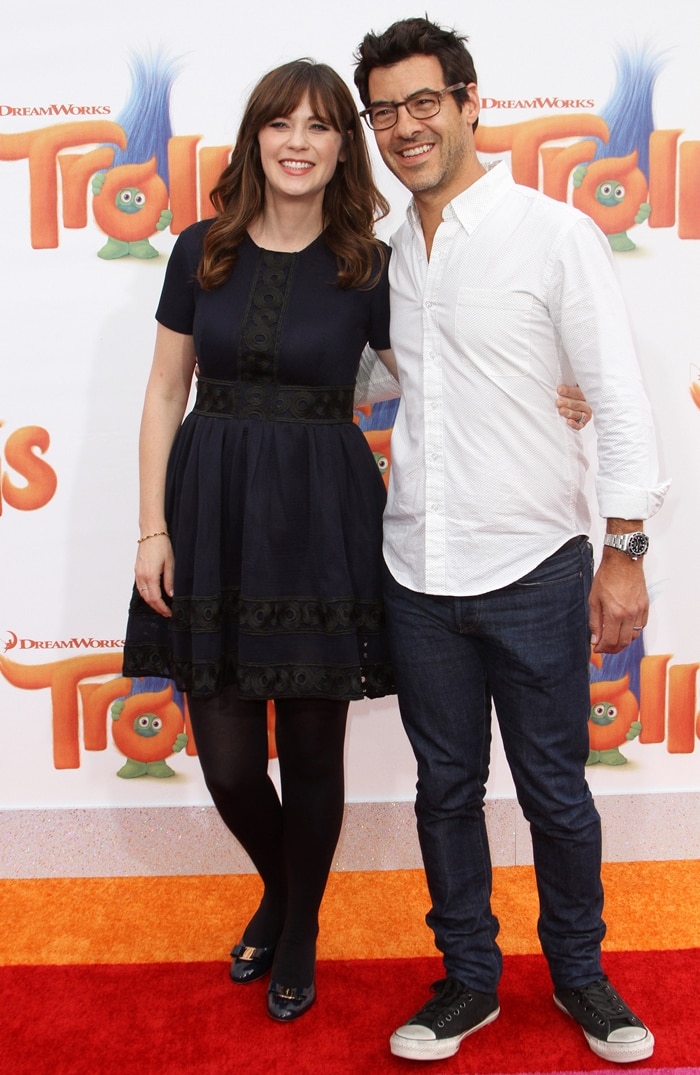 Zooey Deschanel styled her navy fit-and-flare dress with opaque tights and cap-toe ballet flats as she arrived with husband Jacob Pechenik at the Trolls premiere in Los Angeles
