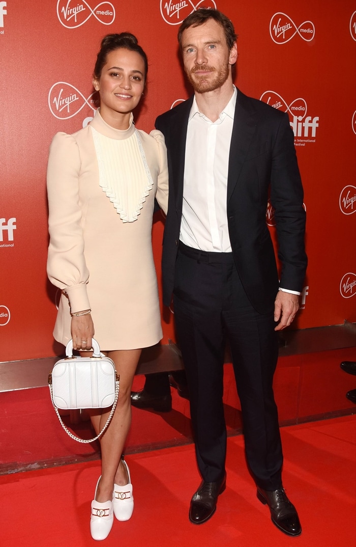 Michael Fassbender and Alicia Vikander looked polished on the red carpet at the 2020 Dublin International Film Festival, with Vikander in a cream Louis Vuitton mini dress styled with white loafers and a matching structured bag