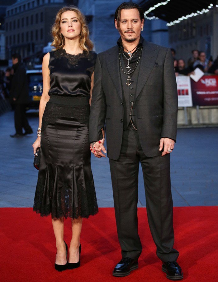 Amber Heard’s black silk Dolce Gabbana dress with lace detailing paired perfectly with Johnny Depp’s dark three-piece suit for a sophisticated red-carpet look
