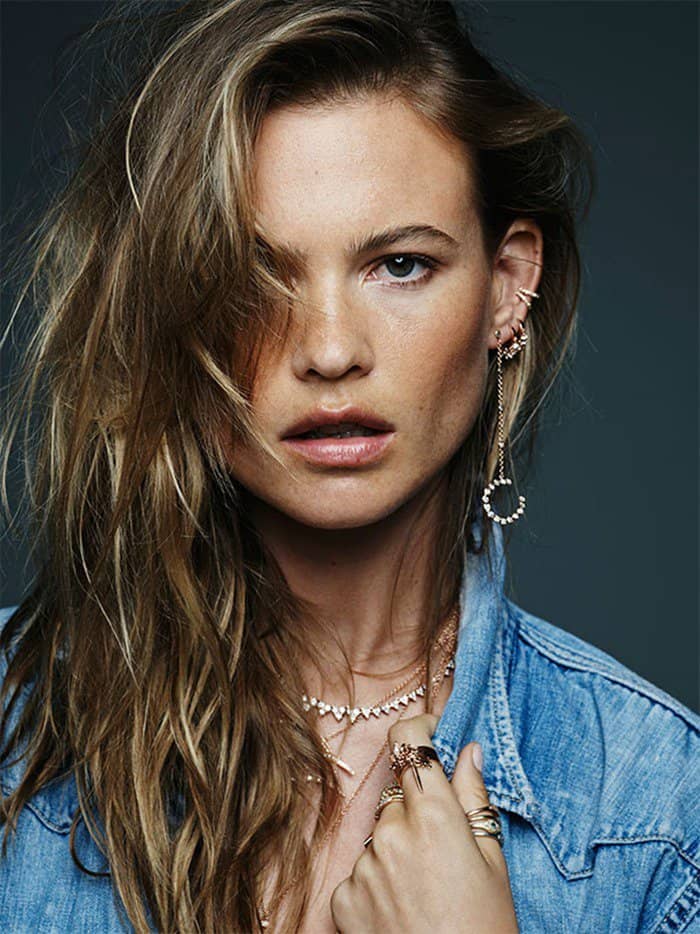 Behati Prinsloo captivates with her intense gaze, wearing layered Jacquie Aiche jewelry that perfectly complements her effortless beauty