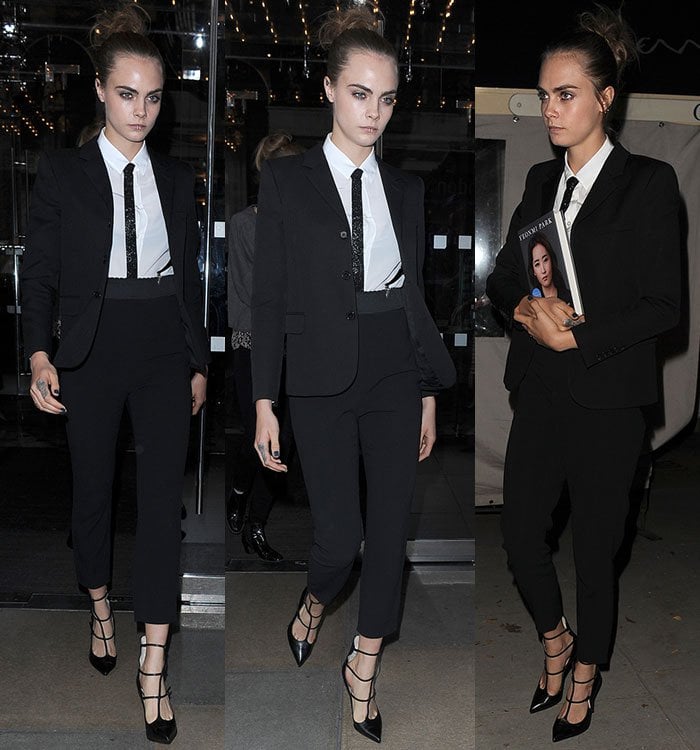 Cara Delevingne stuns in a sleek Saint Laurent suit, adding a fierce edge with a glittery tie, strappy pumps, and a bold lip ring for the Women in the World Summit