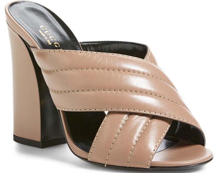 Gucci’s “Sylvia” mule in rose leather showcases wide crossover straps and sturdy heels designed for both comfort and statement appeal