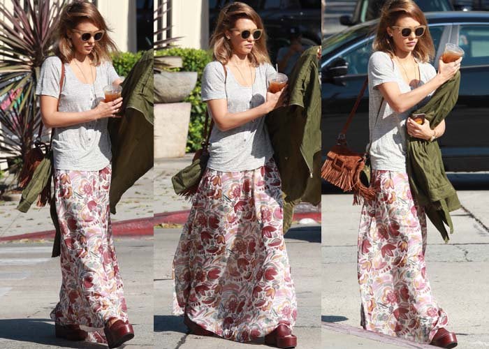 Jessica Alba balances a flowing floral maxi skirt with heavy burgundy Céline wedge sandals, creating a grounded contrast between softness and structure