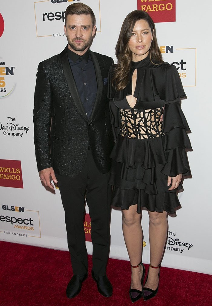 Justin Timberlake and Jessica Biel pose together on the red carpet, coordinating sleek black eveningwear with contrasting textures and silhouettes