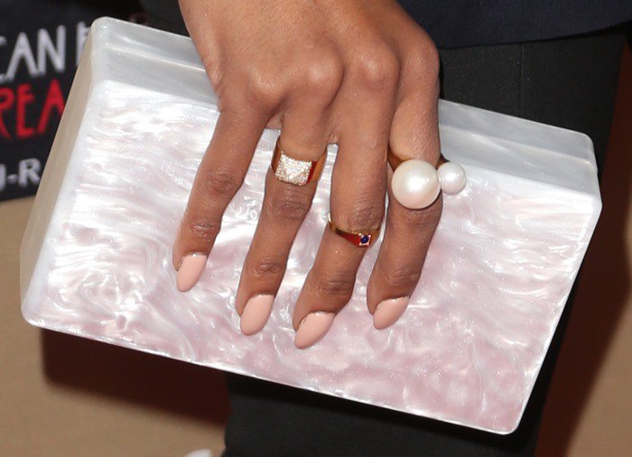 Kat Graham toting an Edie Parker clutch