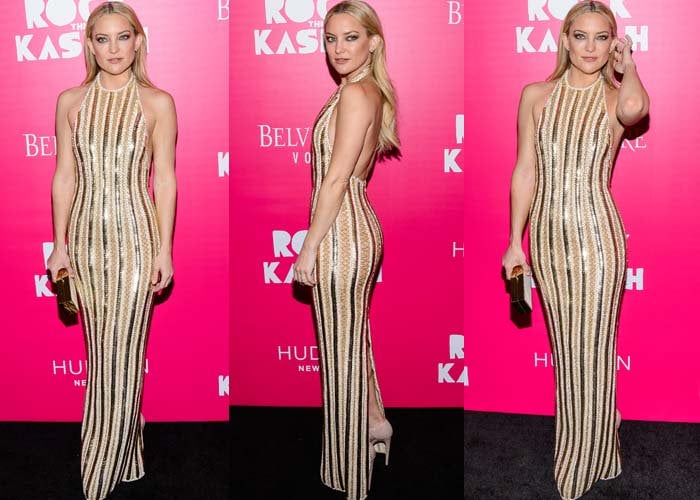 Kate Hudson showcases the body-skimming silhouette and vertical metallic embellishment of her Balmain gown, a look amplified by towering Brian Atwood platform heels peeking beneath the hem