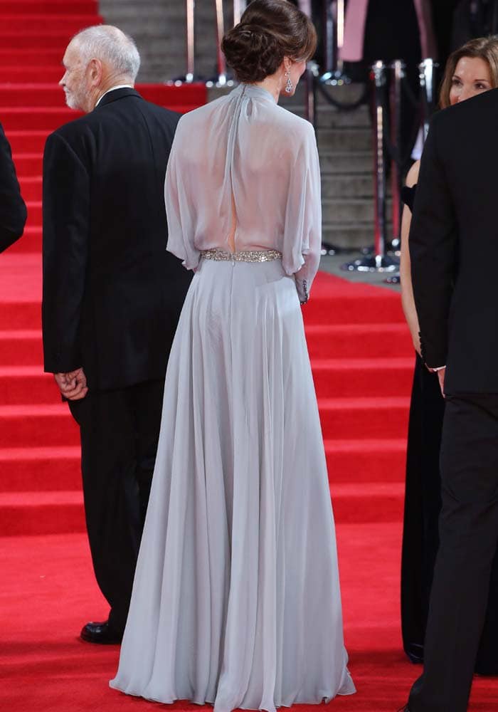 The sheer back of Kate Middleton’s Jenny Packham gown reveals delicate pleating and subtle skin-baring elegance, accented by a crystal-embellished waistband for a refined red carpet statement