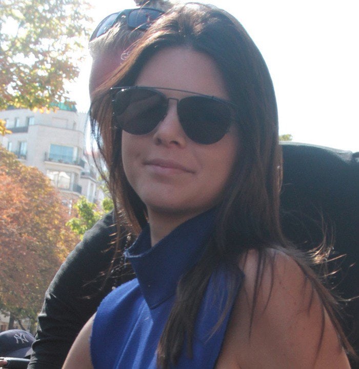 Kendall Jenner steps out in Paris wearing mirrored aviator sunglasses and a bold cobalt-blue halter top during Fashion Week