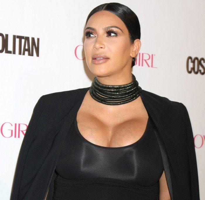 Kim Kardashian's dewy nude makeup enhances her bronzed complexion, perfectly complementing her sleek Wolford tube dress and bold Balmain choker