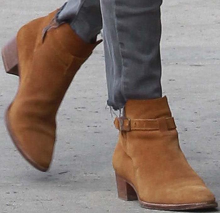 Kourtney Kardashian steps out in rich tan suede Saint Laurent Wyatt boots, adding a touch of effortless edge to her off-duty denim look