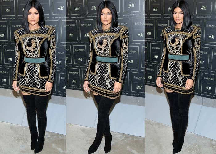 Kylie Jenner pairs an HM x Balmain dress with a pair of Balmain boots at the launch of the HM x Balmain collection