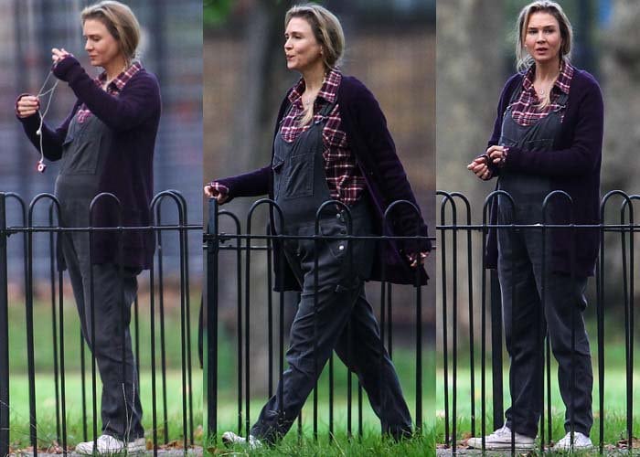 Renée Zellweger films a London scene for Bridget Jones’s Baby, wearing overalls and a cozy cardigan styled by costume designer Steven Noble