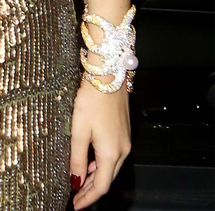 Rita Ora shows off a sparkling octopus-style wrist cuff during a London outing