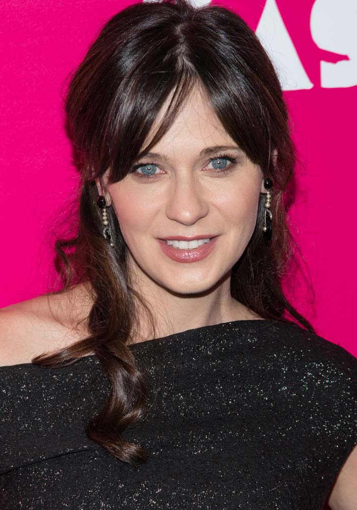 Zooey Deschanel wore softly curled hair and delicate drop earrings with her shimmering Lela Rose dress at the New York premiere of Rock the Kasbah