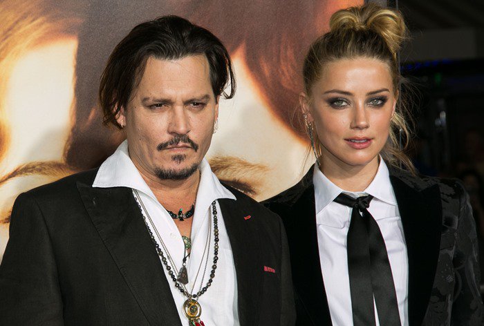 Johnny Depp and Amber Heard pose together on the red carpet at The Danish Girl premiere