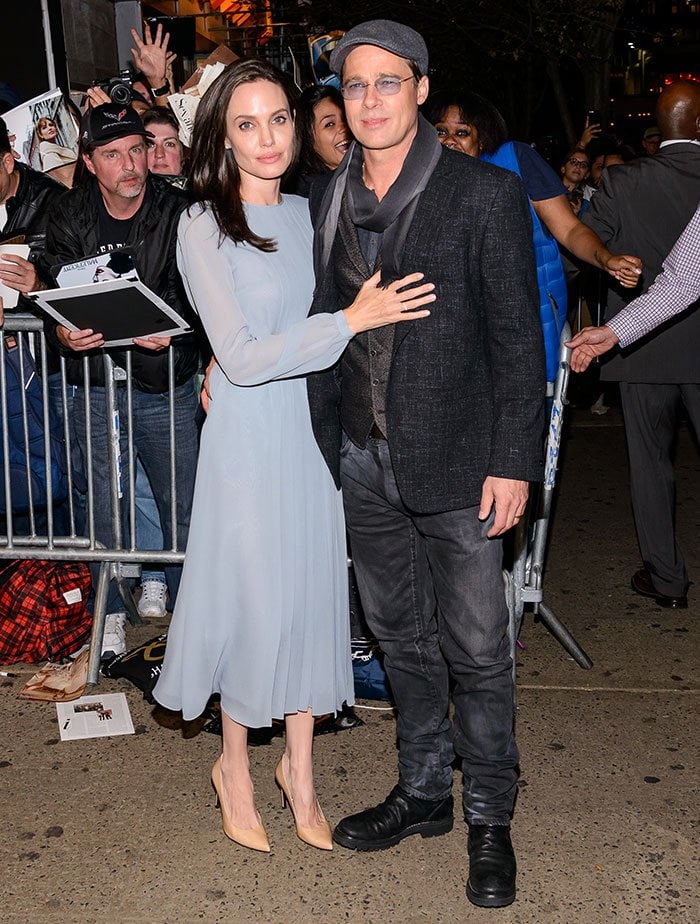 Angelina Jolie poses for photos at the premiere of "By the Sea" with her husband Brad Pitt
