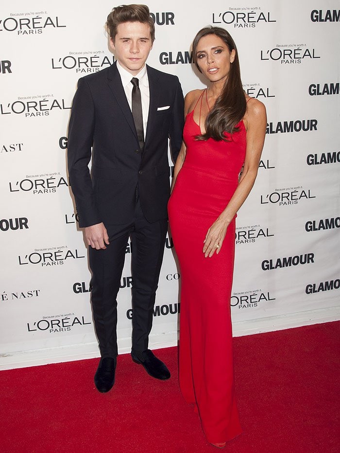 Victoria Beckham attends the 2015 Glamour Women of the Year Awards at Carnegie Hall alongside her son Brooklyn, letting a sleek red gown set the stage for a streamlined, head-to-toe red-carpet moment