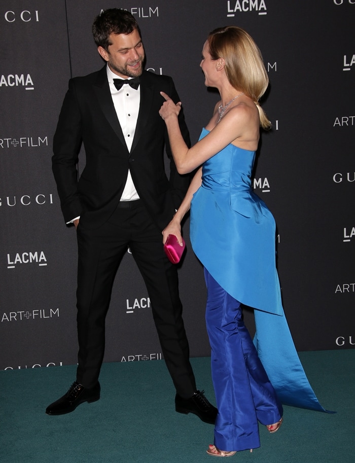 Diane Kruger shares a candid red-carpet moment with Joshua Jackson, showcasing the architectural lines of her sky-blue strapless ensemble paired with sleek metallic sandals