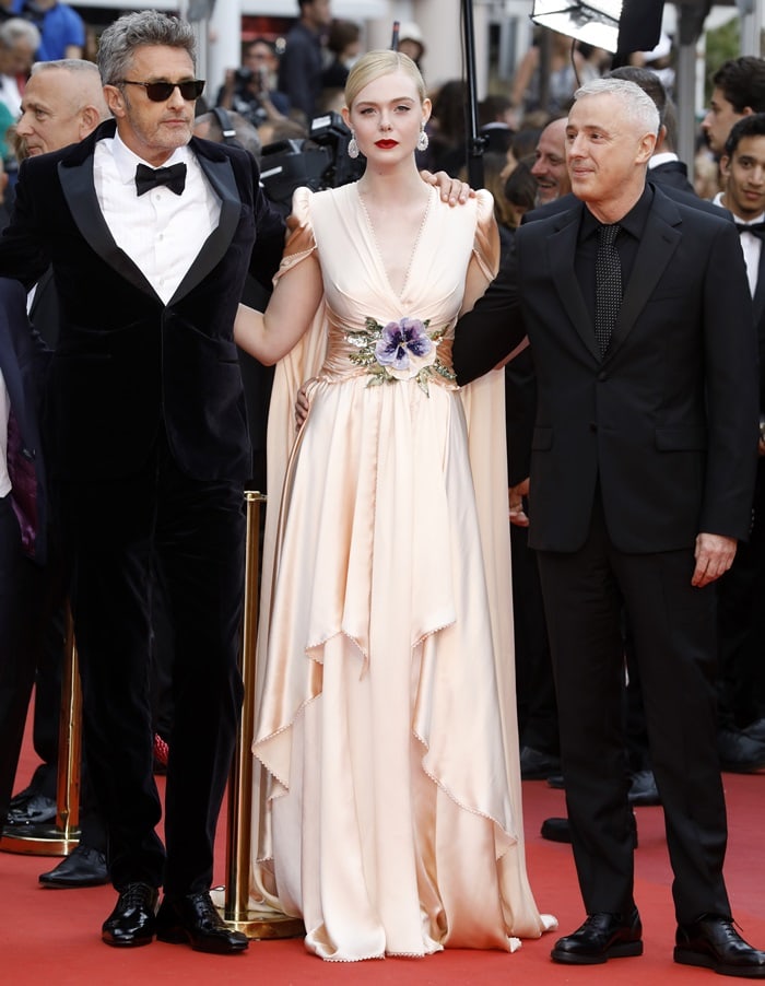 Elle Fanning elevated her soft, Grecian-inspired Gucci gown with towering platform heels, using the added height and stability to balance the dramatic drape and confidently navigate the Cannes red carpet alongside fellow jury members Kelly Reichardt and Pawel Pawlikowski