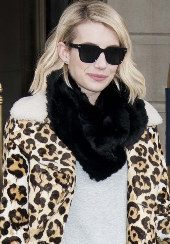 Emma Roberts lets the statement outerwear do the talking, pairing oversized sunglasses and a plush black scarf with a bold leopard-print coat