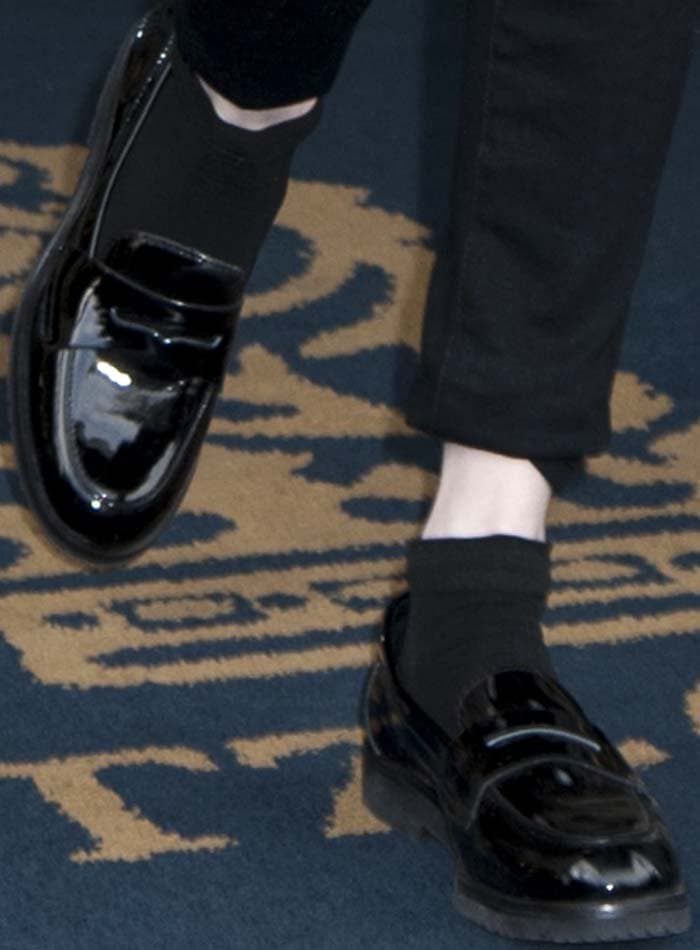 Glossy Vince Camuto "Mitchell" penny loafers add a menswear-inspired finish to the actress's sleek black separates