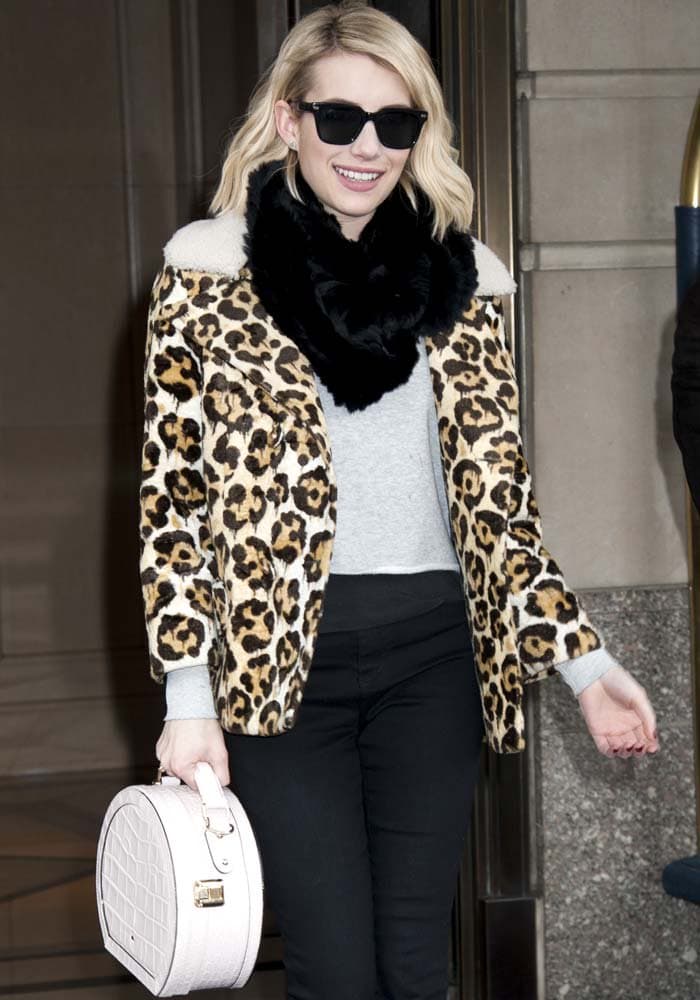 Stepping out in Manhattan, Emma Roberts balances classic wardrobe basics with eye-catching animal print and a structured Kate Spade bag