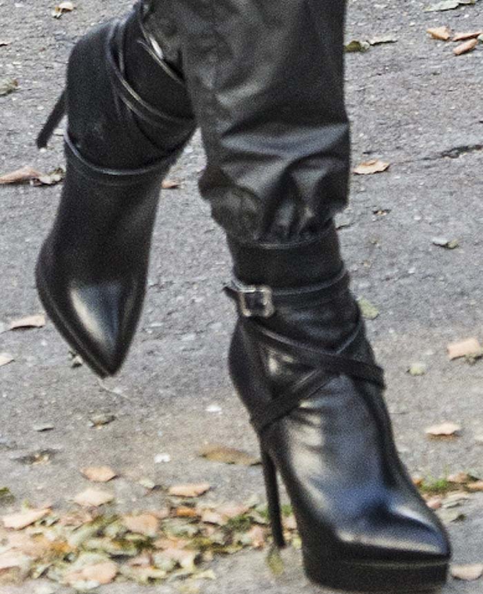 Heidi Klum steps out in black Saint Laurent Janis boots, featuring a sleek pointed toe, high heel, and platform sole