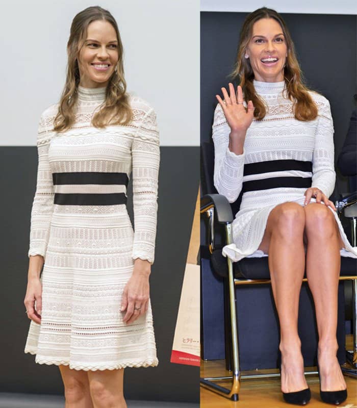 Hilary Swank effortlessly blends sophistication and modern elegance in a white Alexander McQueen knit dress featuring a flattering A-line silhouette and bold black accents, perfectly complemented by her classic black pumps