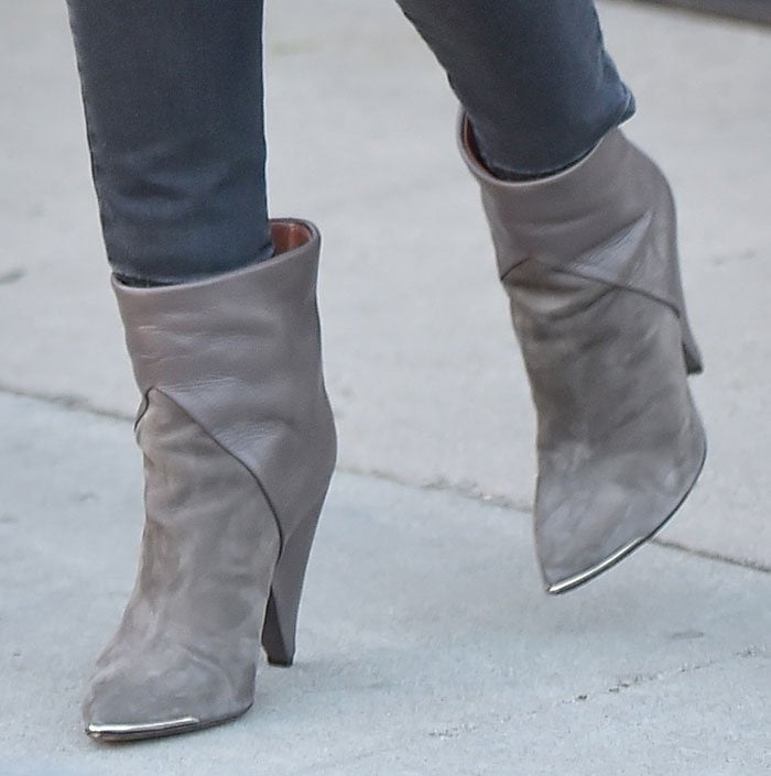 Jessica Alba steps out in gray suede Iro “Daithy” booties featuring pointed toes, polished metal trim, and sculpted cone heels