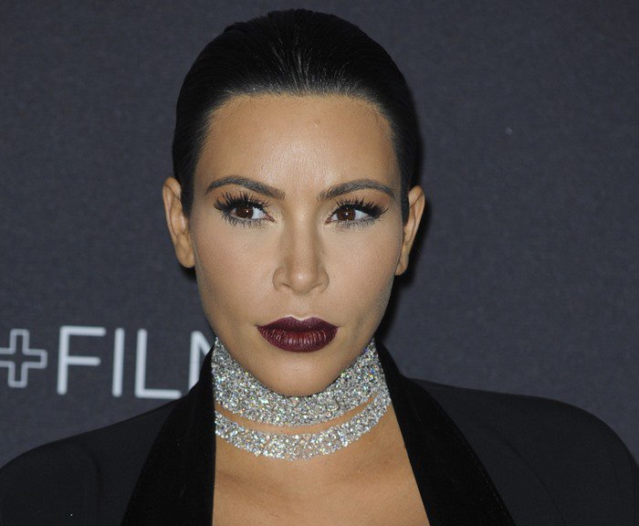 Kim Kardashian pairs a bold burgundy lip and sleek updo with a dazzling multi-strand diamond choker necklace