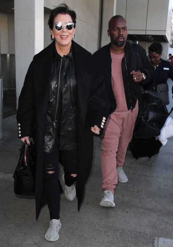 Kris Jenner and Corey Gamble coordinate their travel style with matching Adidas Yeezy Boost 350 "Moonrock" sneakers, one of the most coveted Yeezy releases of 2015