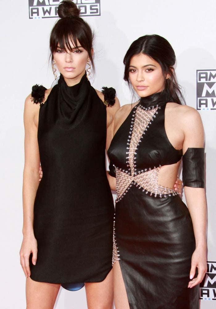 Kendall and Kylie Jenner strike a stylish pose on the red carpet at the 2015 American Music Awards