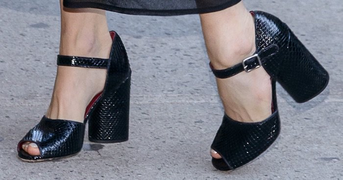 Sienna Miller shows off her feet in sleek black snakeskin block-heeled sandals with a peep toe and ankle strap