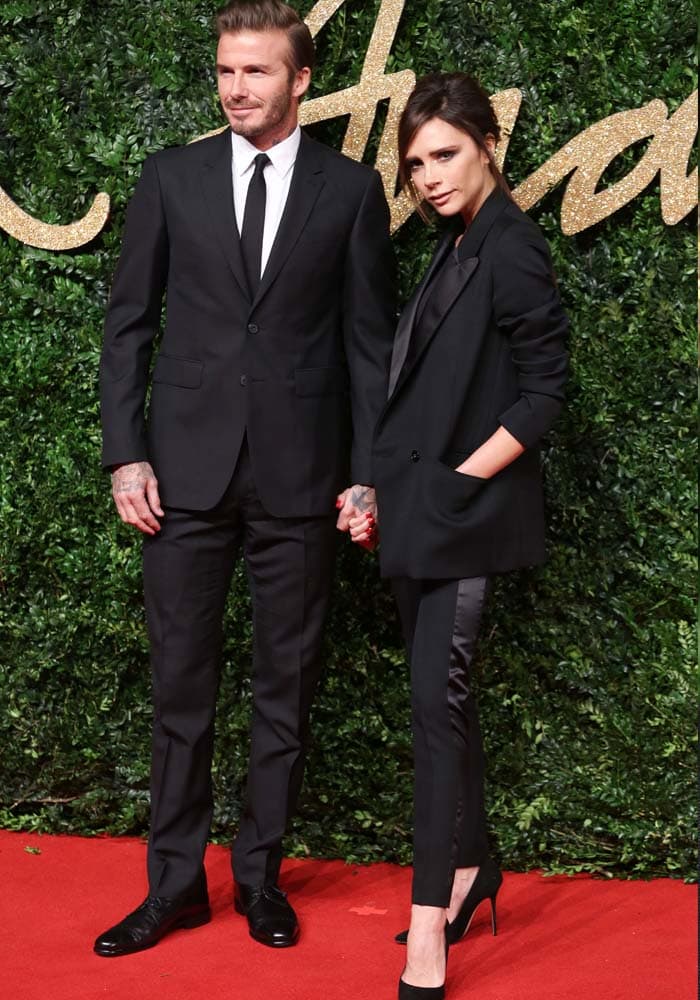 David and Victoria Beckham make coordinated black tailoring look effortlessly polished, with her pointed Manolo Blahnik pumps providing the feminine counterpoint to his classic lace-up shoes