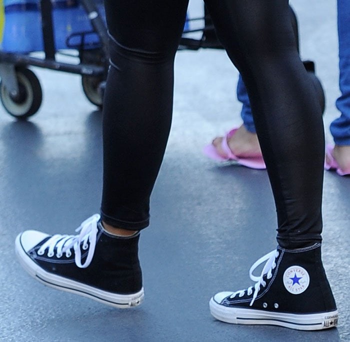 The signature Converse Chuck Taylor All Star high-tops feature the brand’s iconic star logo patch, a symbol of timeless sneaker style
